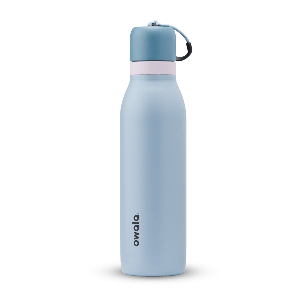 FreeSip Twist 18oz in Rainstorm, light powder blue insulated water bottle with darker slate blue twist cap, pale pink twist cap accent band, and dark navy carry string