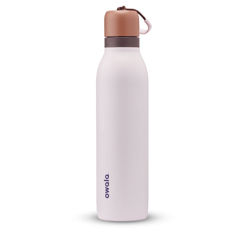 FreeSip Twist 24oz in Sleepy Lavender, soft pale lavender insulated water bottle with copper-orange twist cap, dark plum twist cap accent band, and pink carry string with brown grip